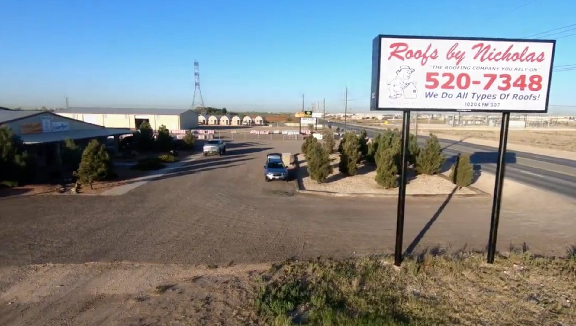 Roofs by Nicholas business sign and office entrance view from roadside in Texas