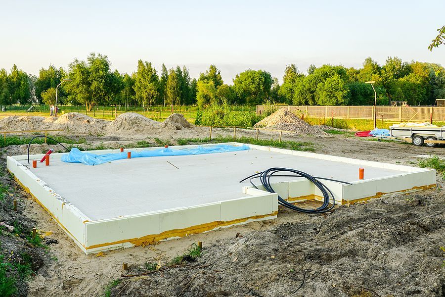 a construction site with a large slab of concrete in the foreground