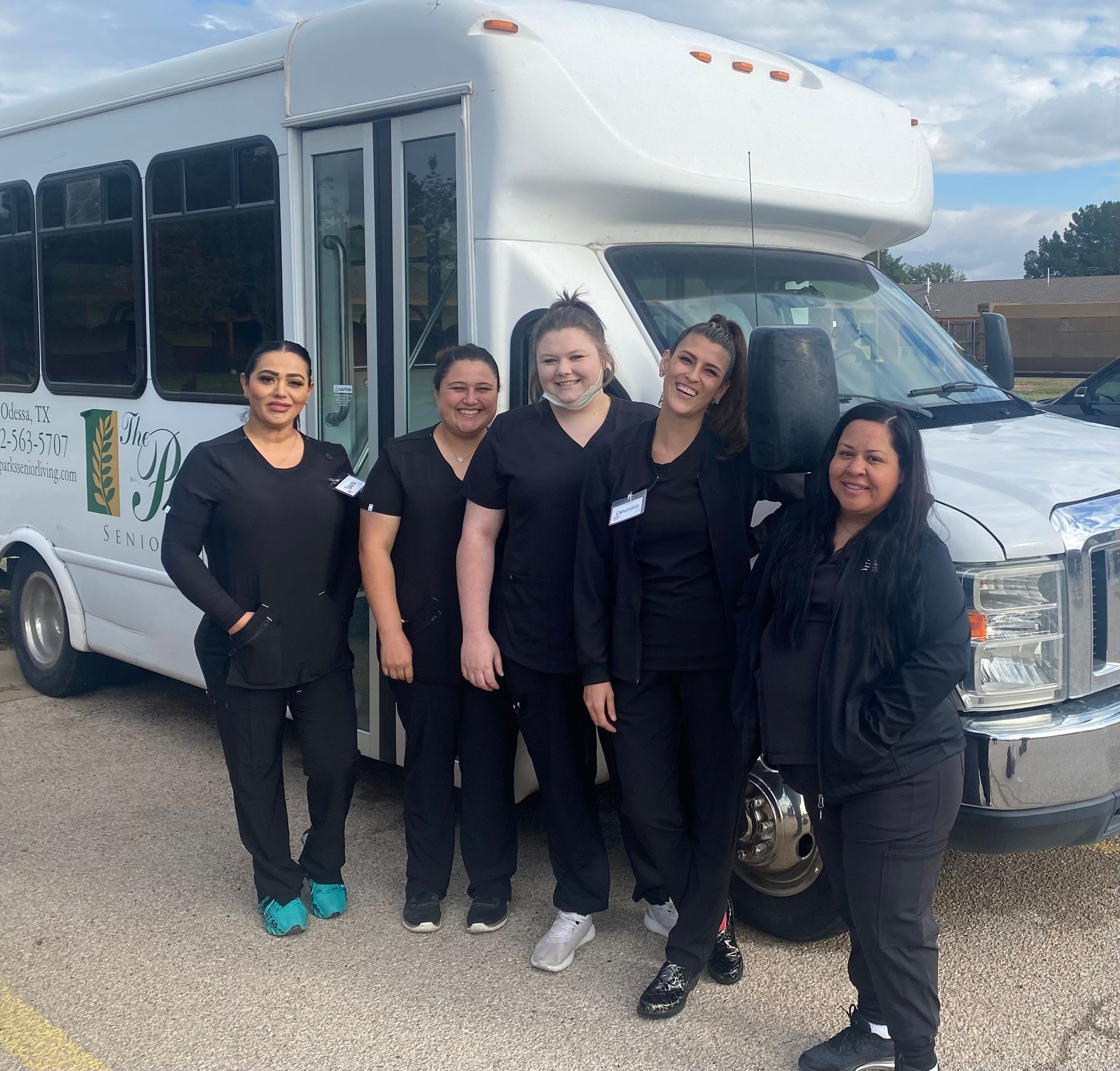 A group of nurses are posing for a picture with a mannequin.