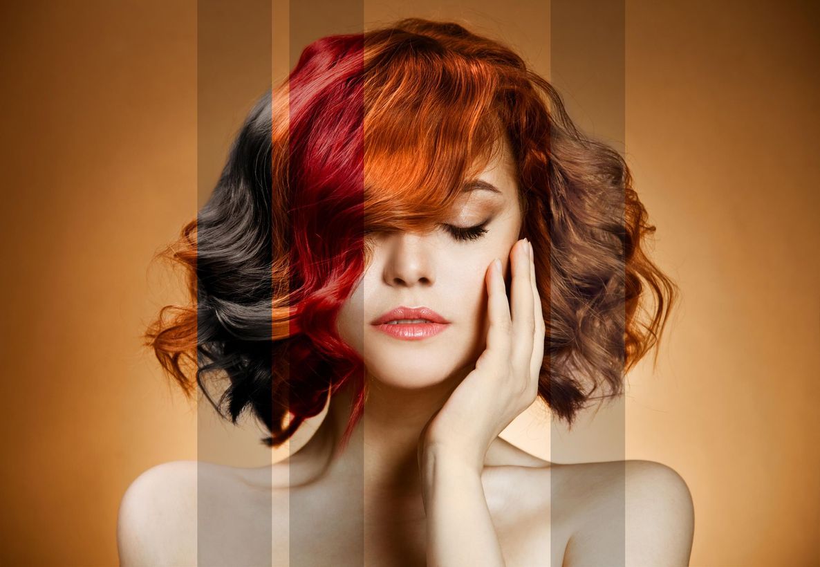 a woman with different shades of hair is covering her face with her hand .