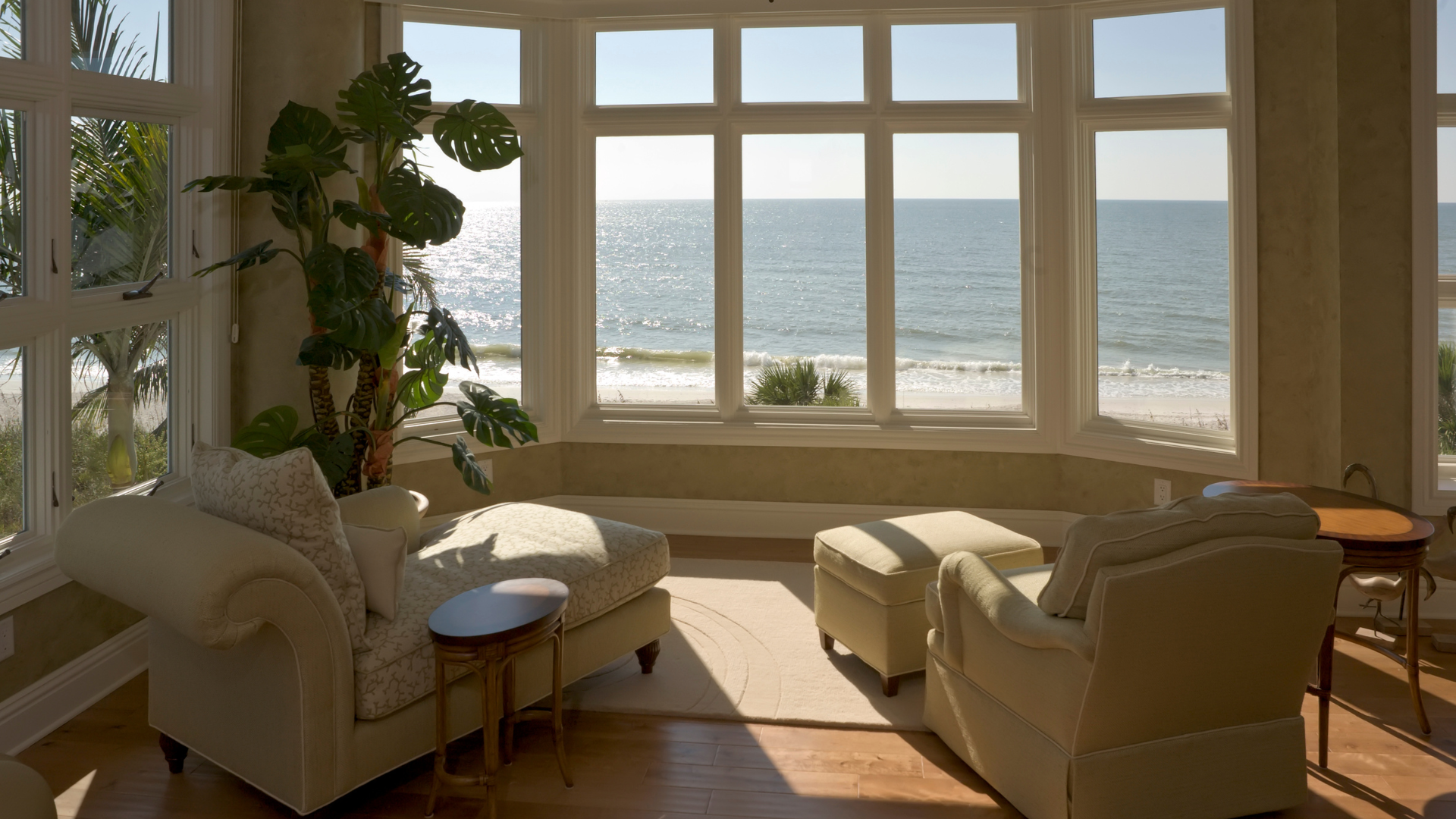 A model house is sitting on top of a pile of money.