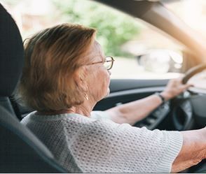 Senior driver receiving a supportive driving safety review