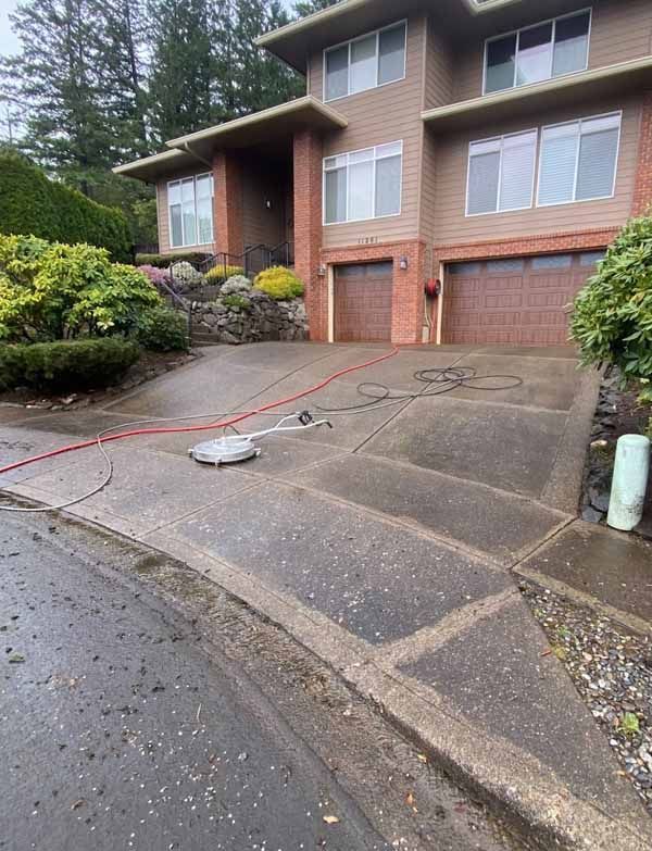 A large house with a concrete driveway in front of it.