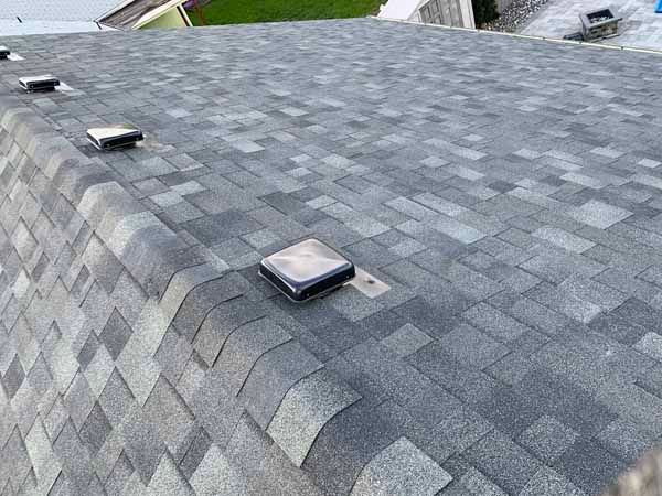 A roof with a lot of shingles and a light on it.