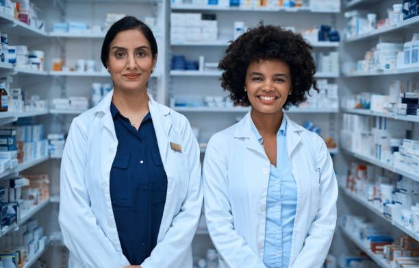 Two female pharmacists are standing next to each other in a pharmacy - Buford, GA - North Georgia Veterinary Specialists 