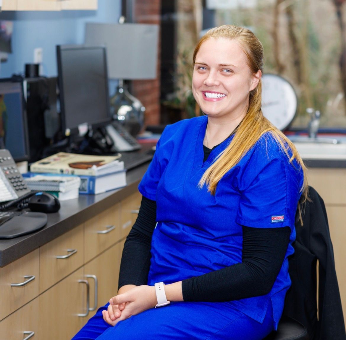 A little girl is looking at a kitten being examined by a veterinarian - Buford, GA - North Georgia Veterinary Specialists 
