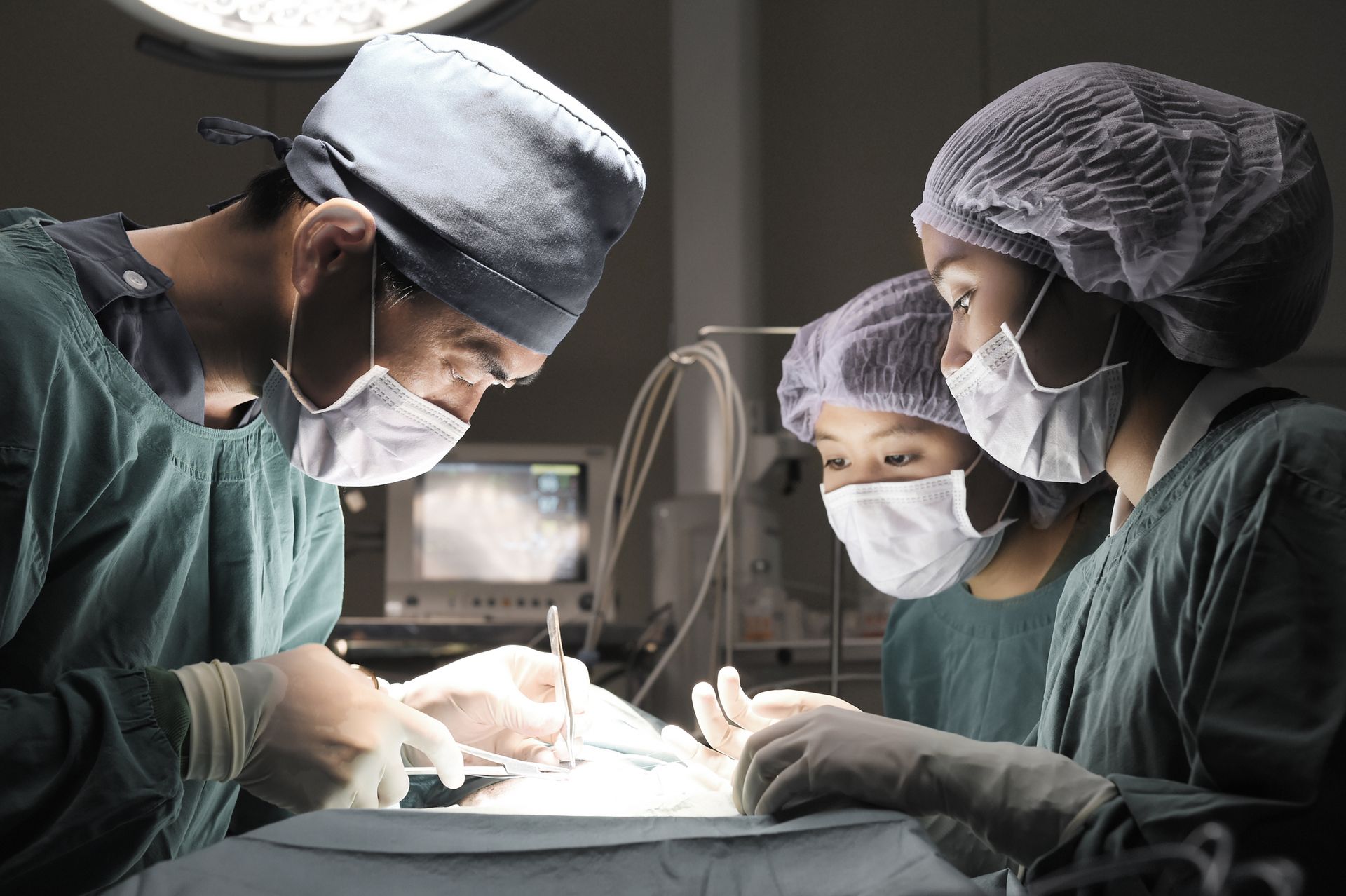 A group of surgeons are operating on a patient in an operating room - Buford, GA - North Georgia Veterinary Specialists 