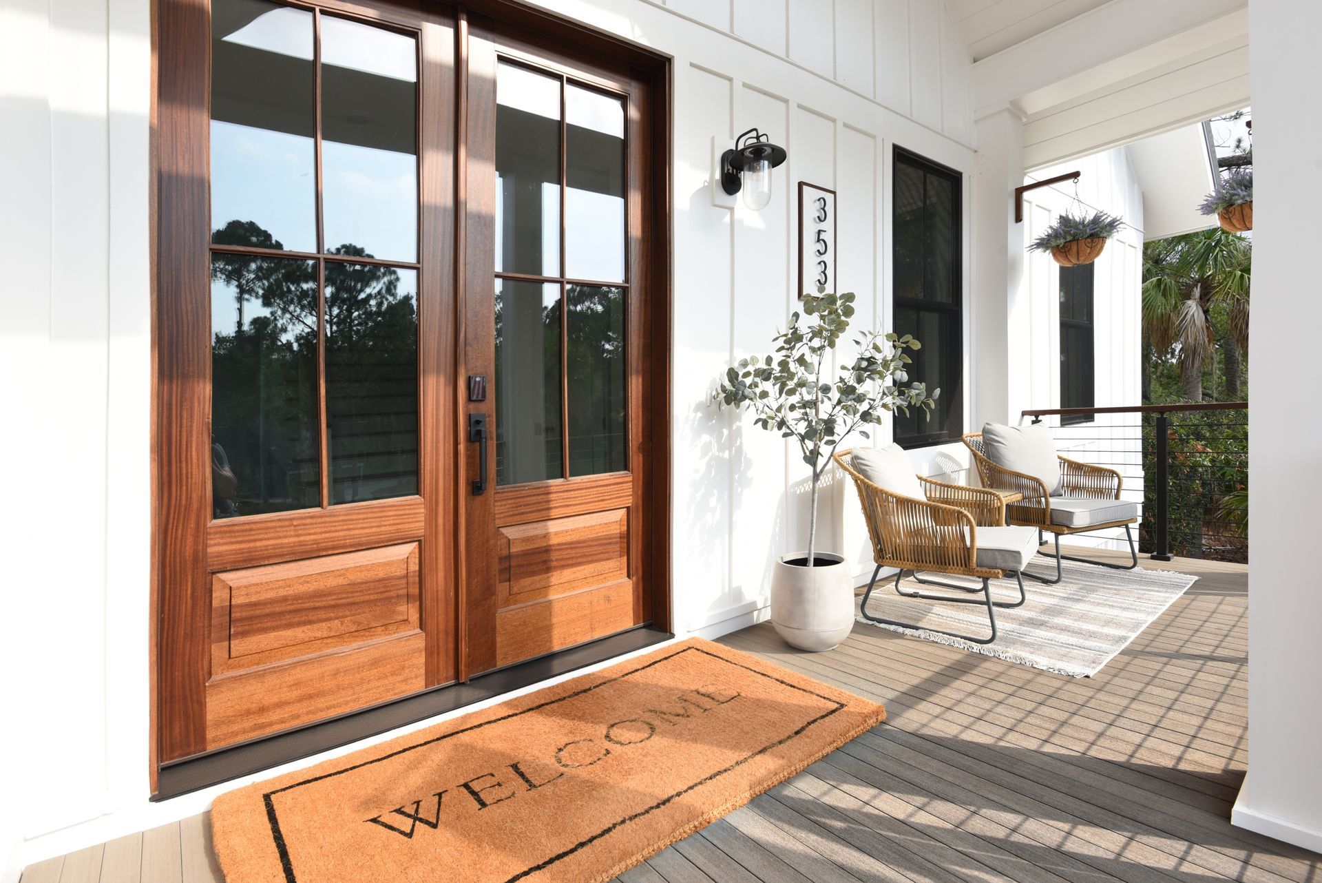 There is a welcome mat on the porch of a house.