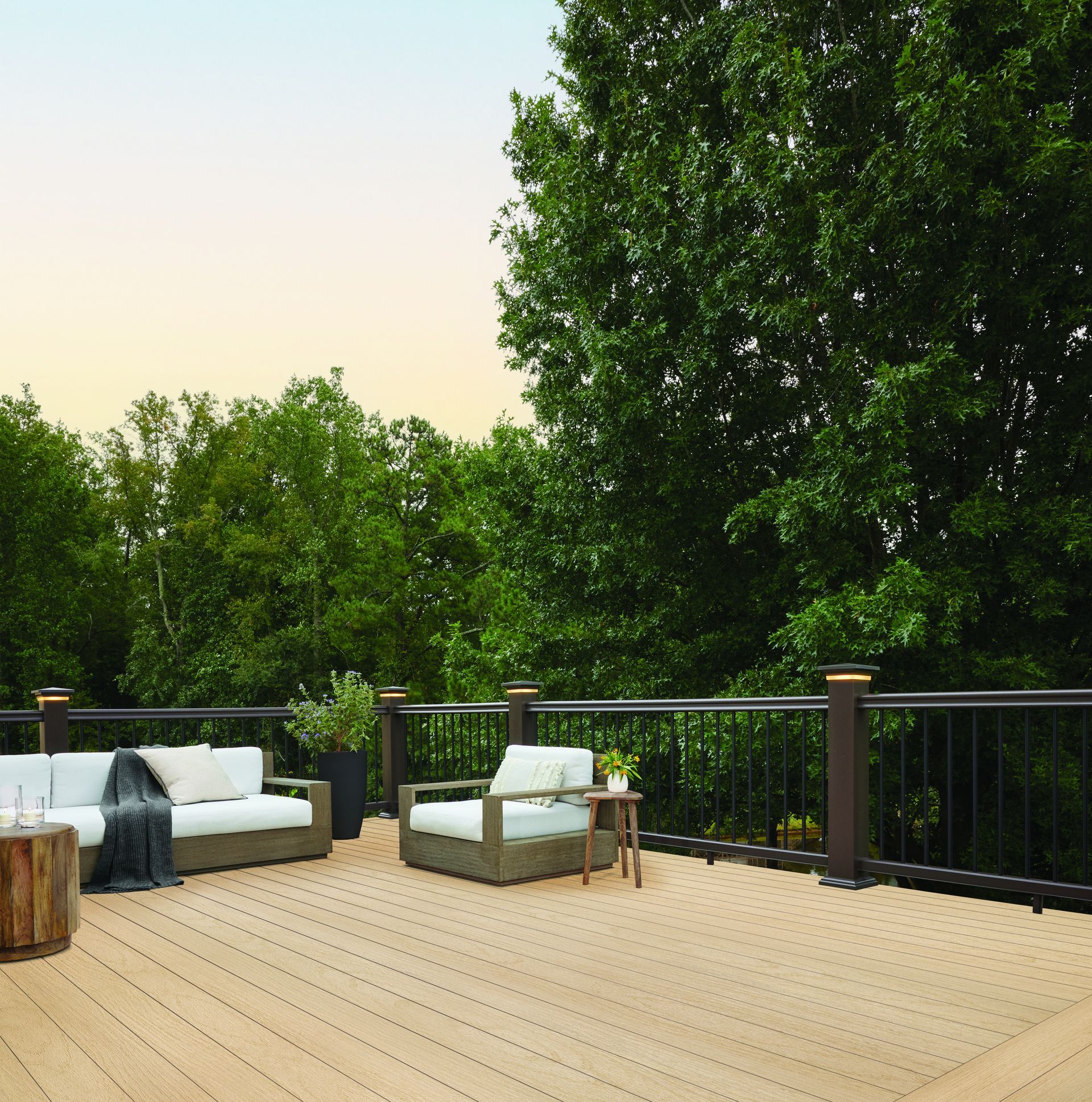 A wooden deck with a couch and chairs on it