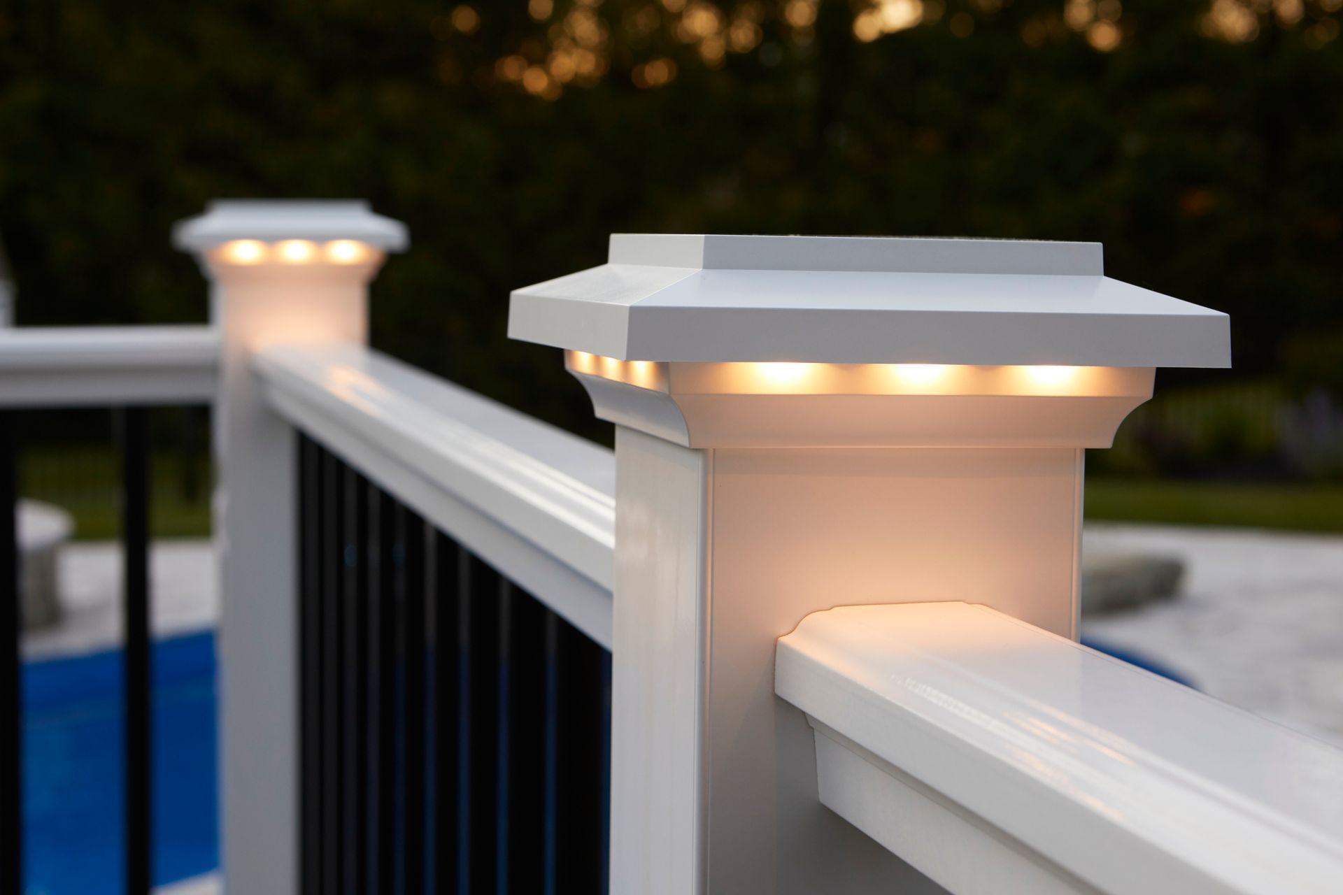 A close up of a white railing with lights on it