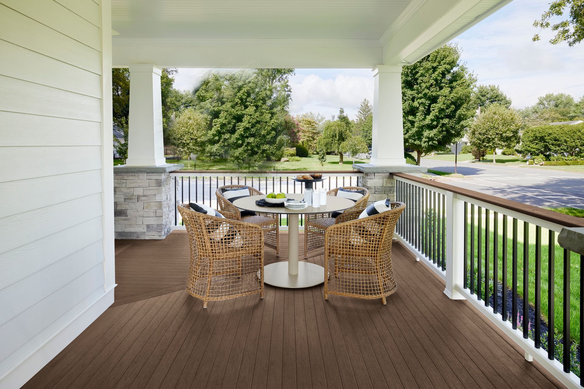 A porch with a table and chairs on it