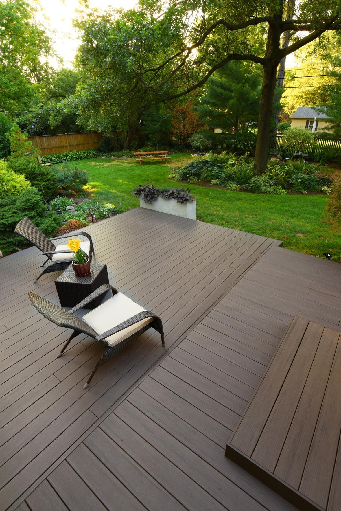 A wooden deck with chairs and a table on it