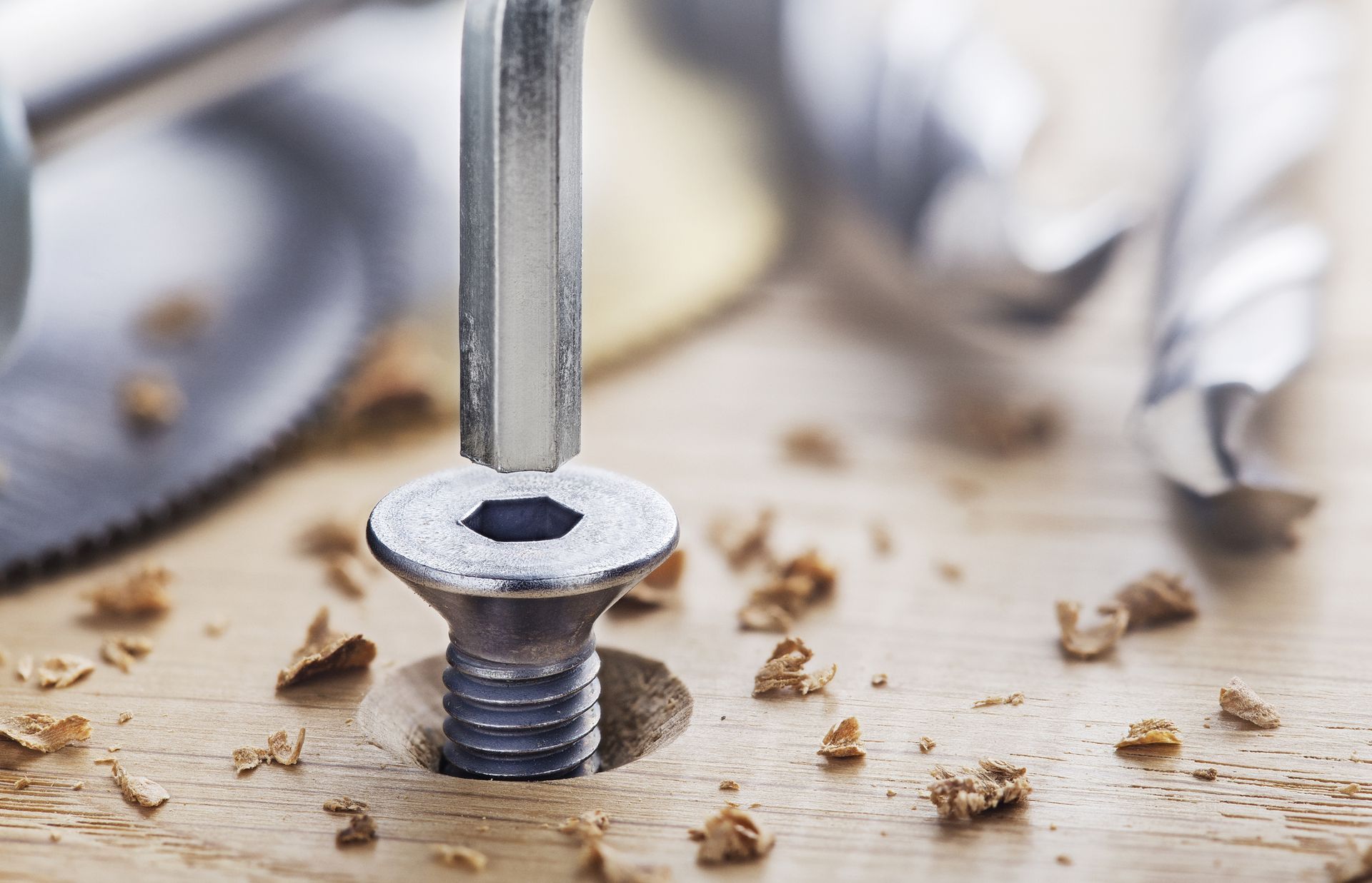 A screw is being drilled into a piece of wood.