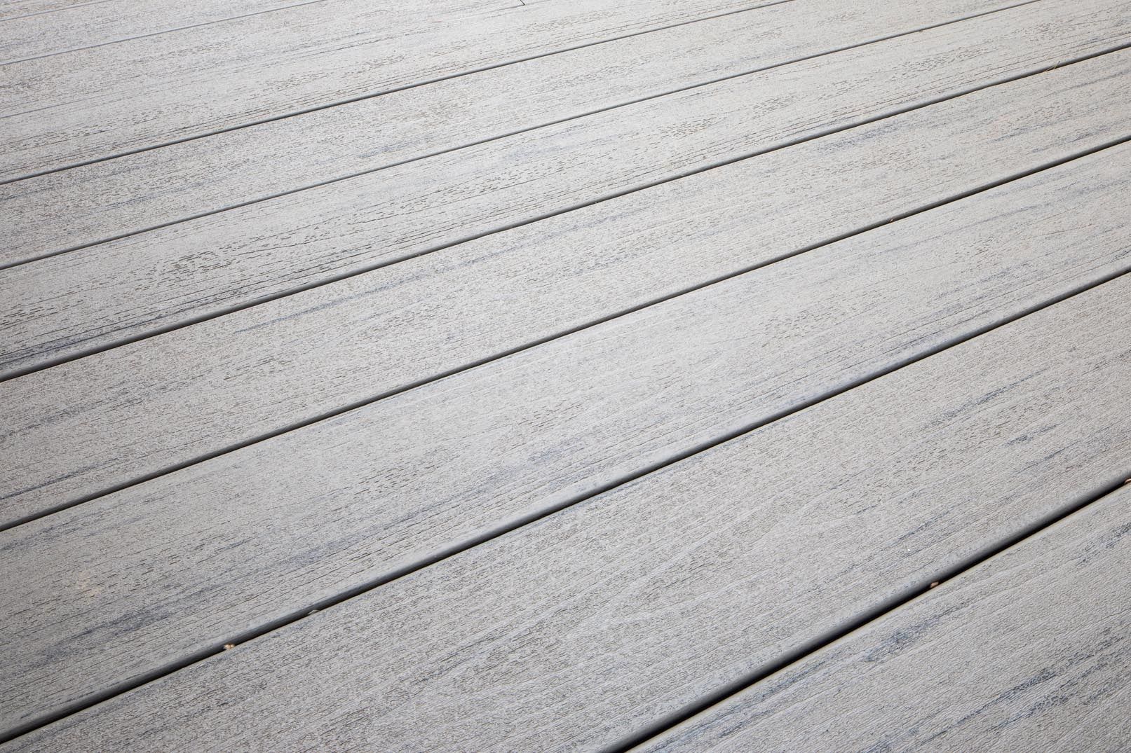 A close up of a white wooden deck with black lines.