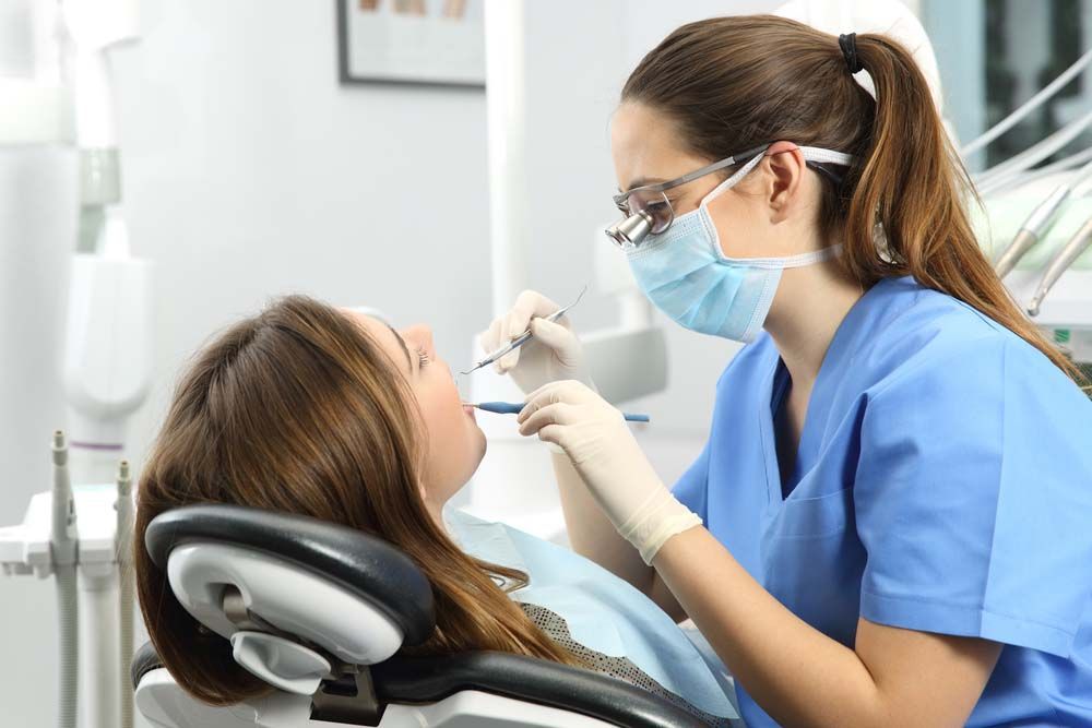 dentist checking a patient’s teeth