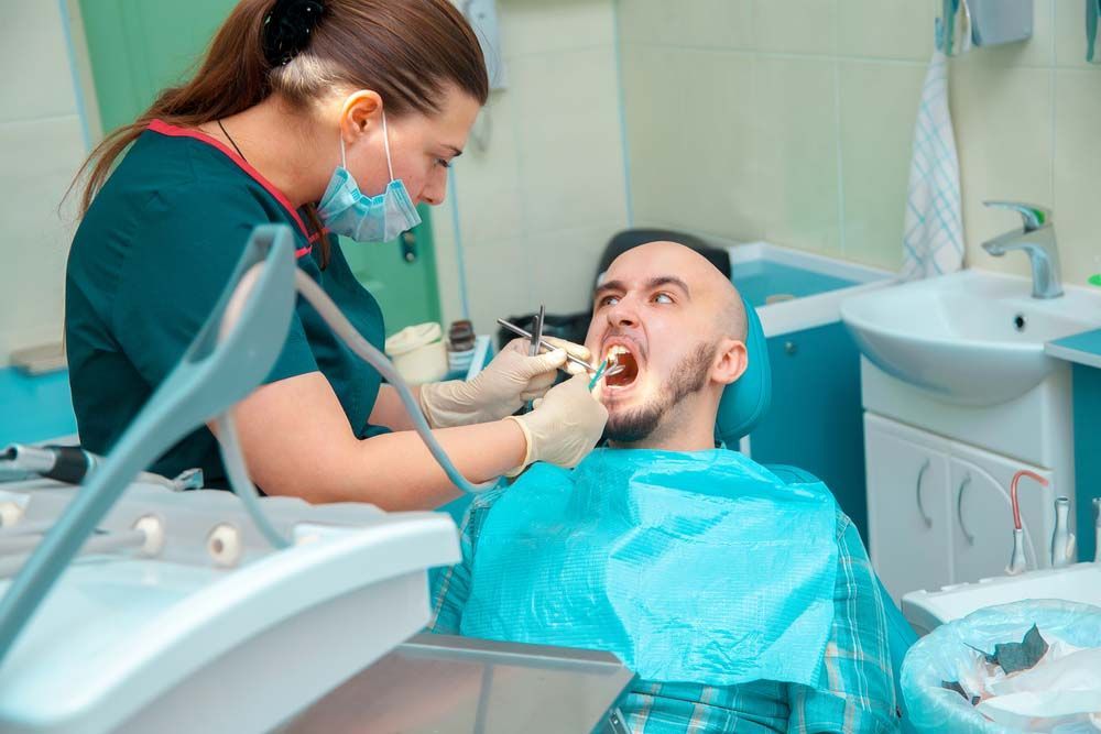 dentist checking a patient’s teeth