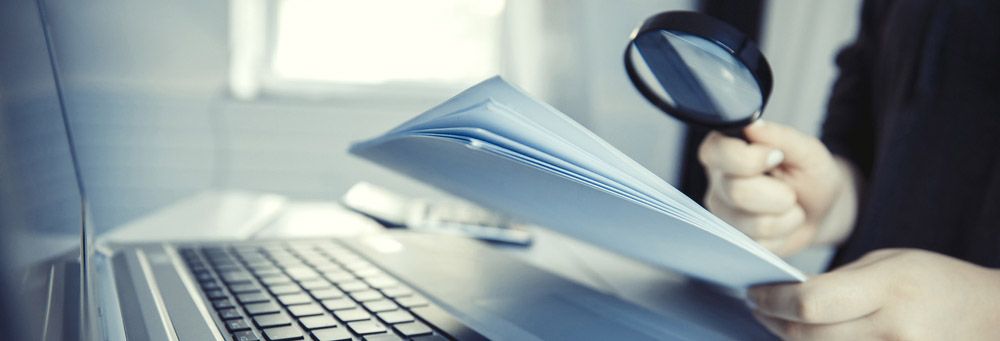 magnifying glass hovering over fine print