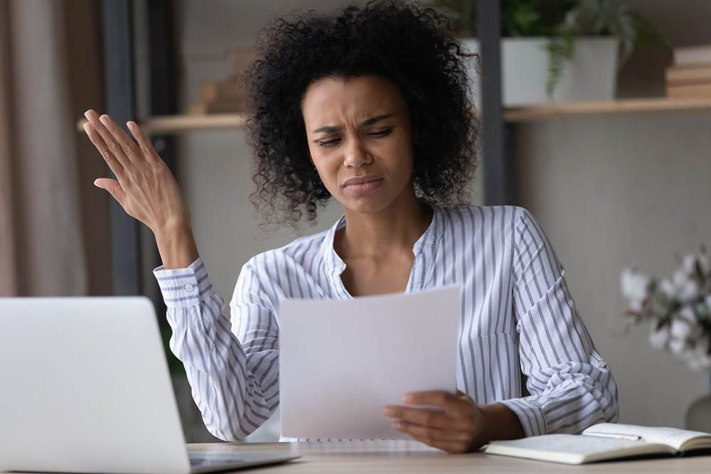 person with a surprised face (while looking at a policy)