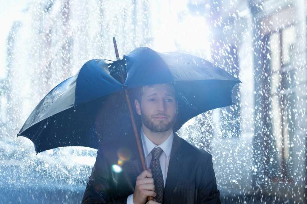 (wet) person under a broken umbrella