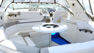 The inside of a boat with a table and chairs