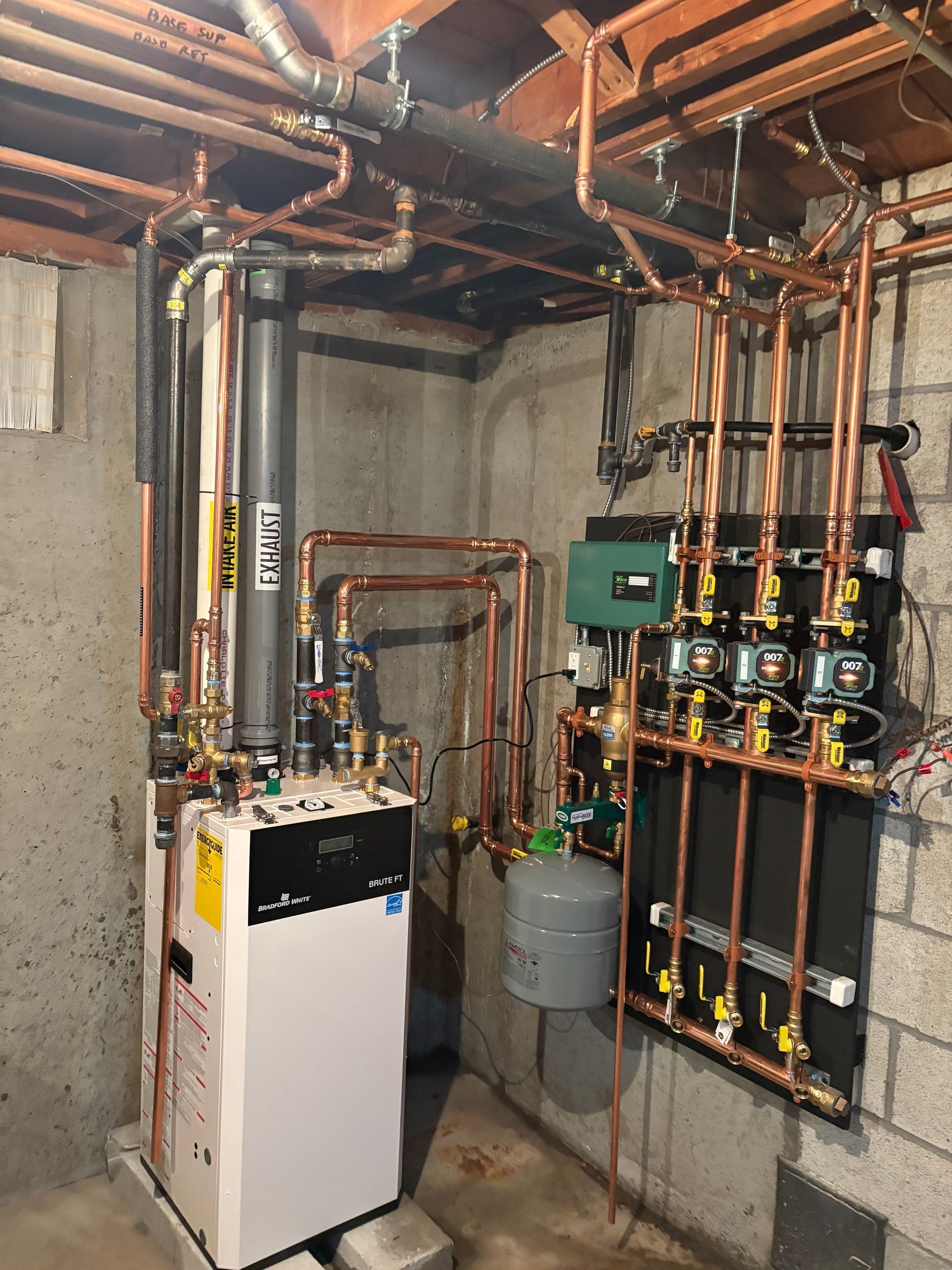 Furnace and other mechanical equipment in a basement with exposed wooden beams and pipes.