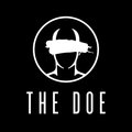 Black logo of a horned face in a circle above the words āTHE DOEā