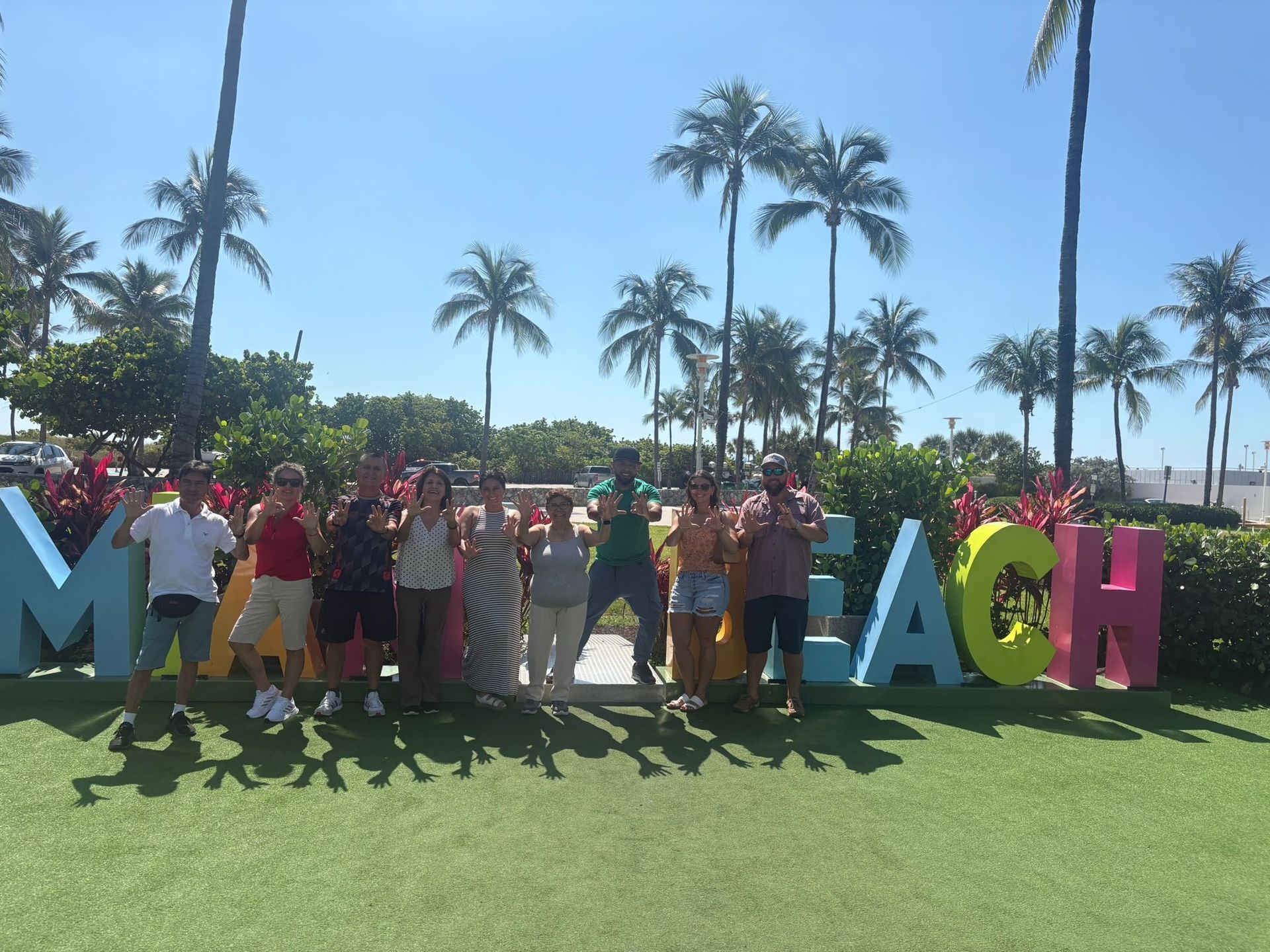 Guest in Miami Beach, taking photos in the South Beach Walking tour of the Miami Beach sign. 