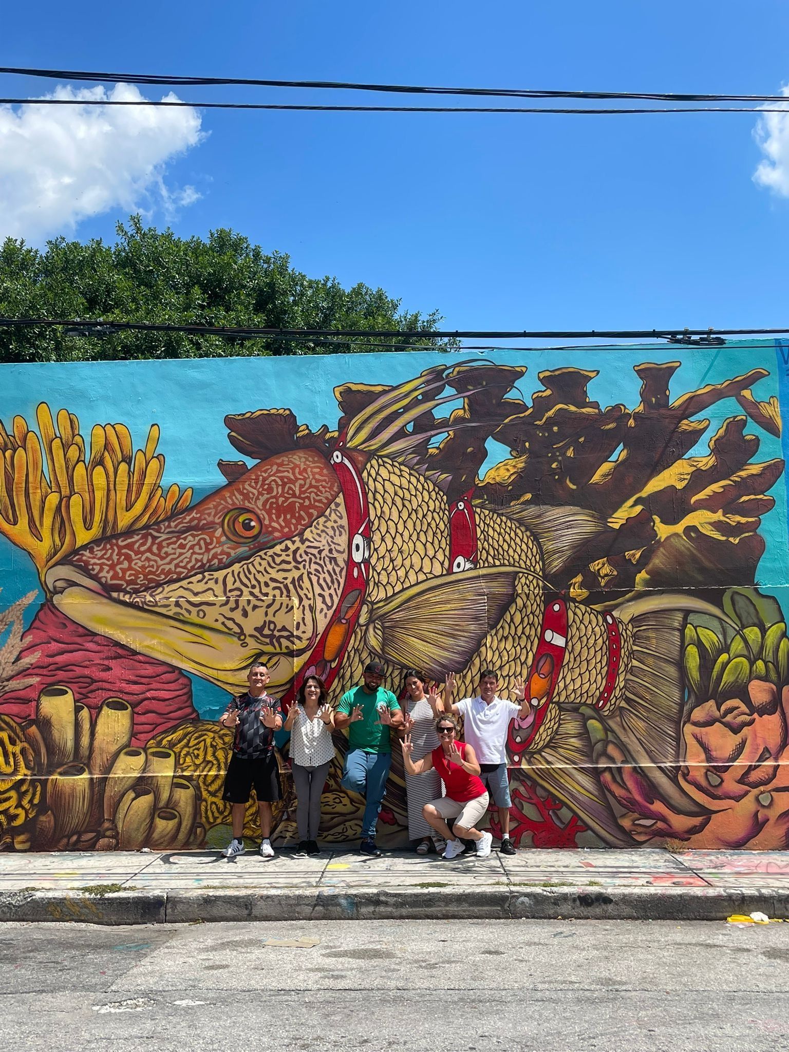 Passengers in Wynwalls with tour gude taking photos on the 5 in 1 Miami Bus tours