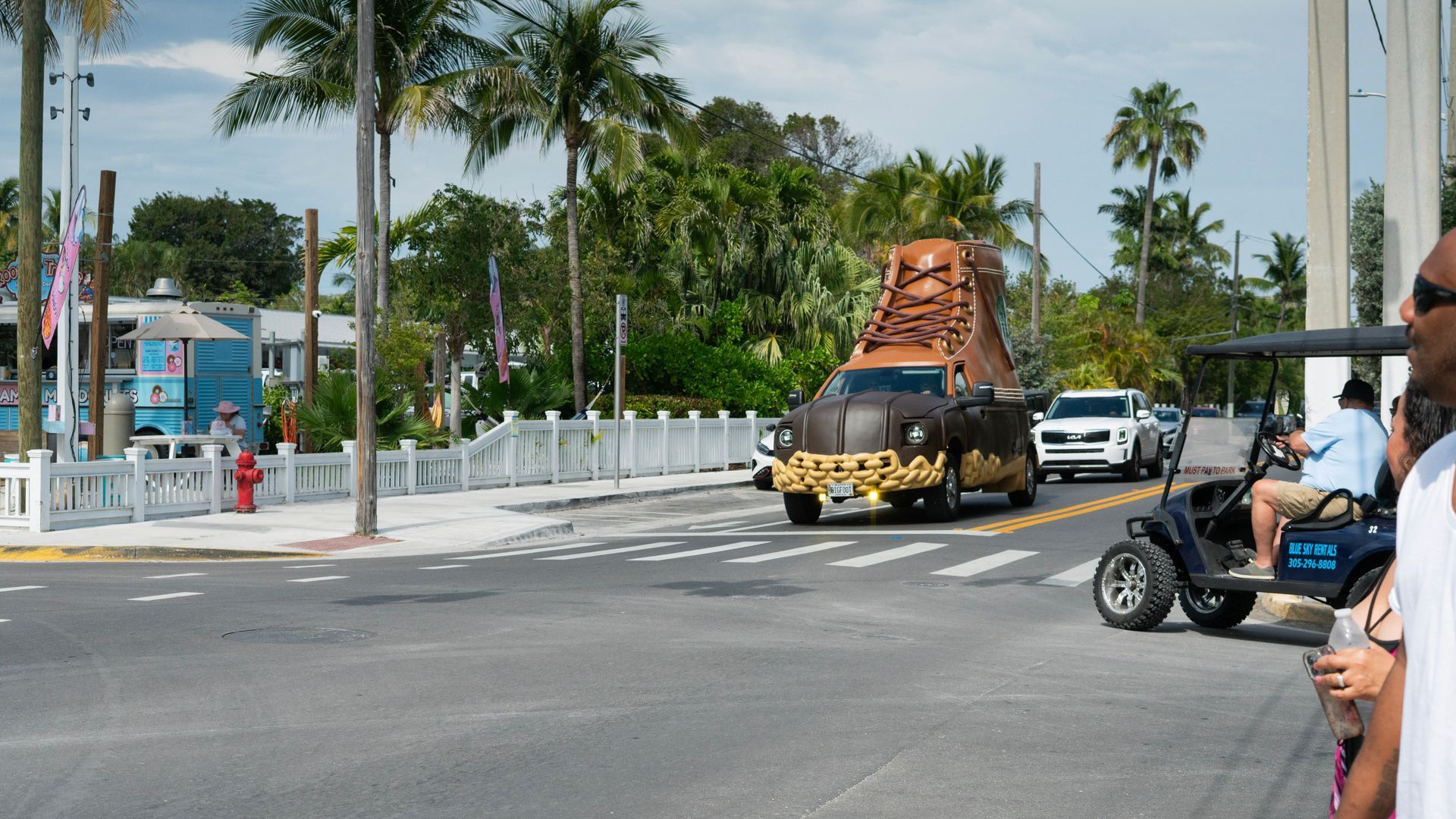 Quirky oversized boot car driving through the streets of Key West, spotted on a fun Florida Keys sightseeing trip from Miami to Key West