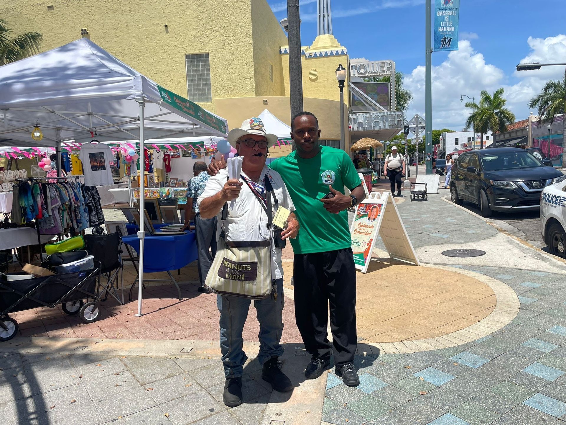 Tour Guide of the Small Group Miami City Bus Tour taking photo with the peanut man in Little Havana