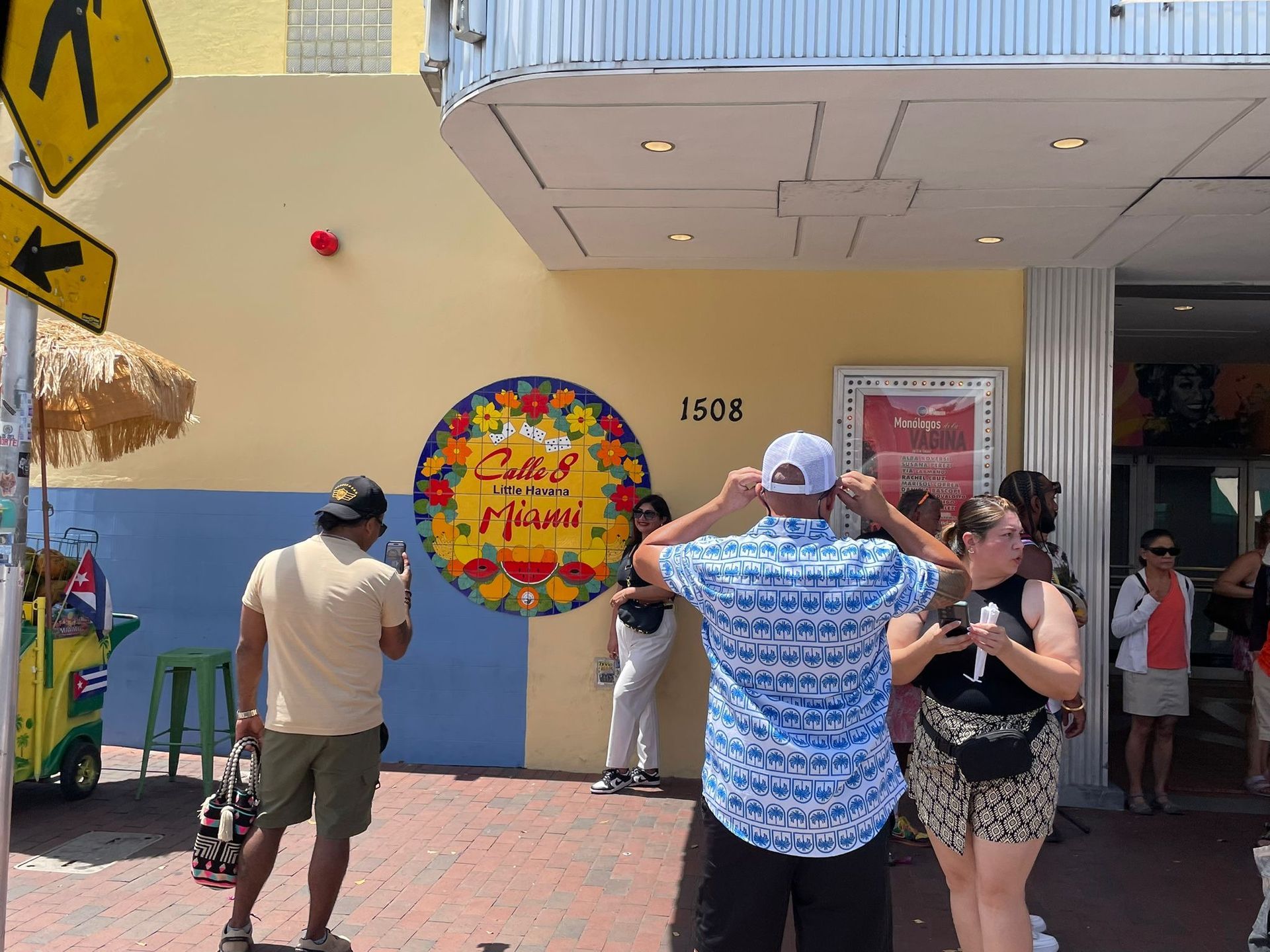 Passengers in the Calle Ocho sign in little Havana taking photos.