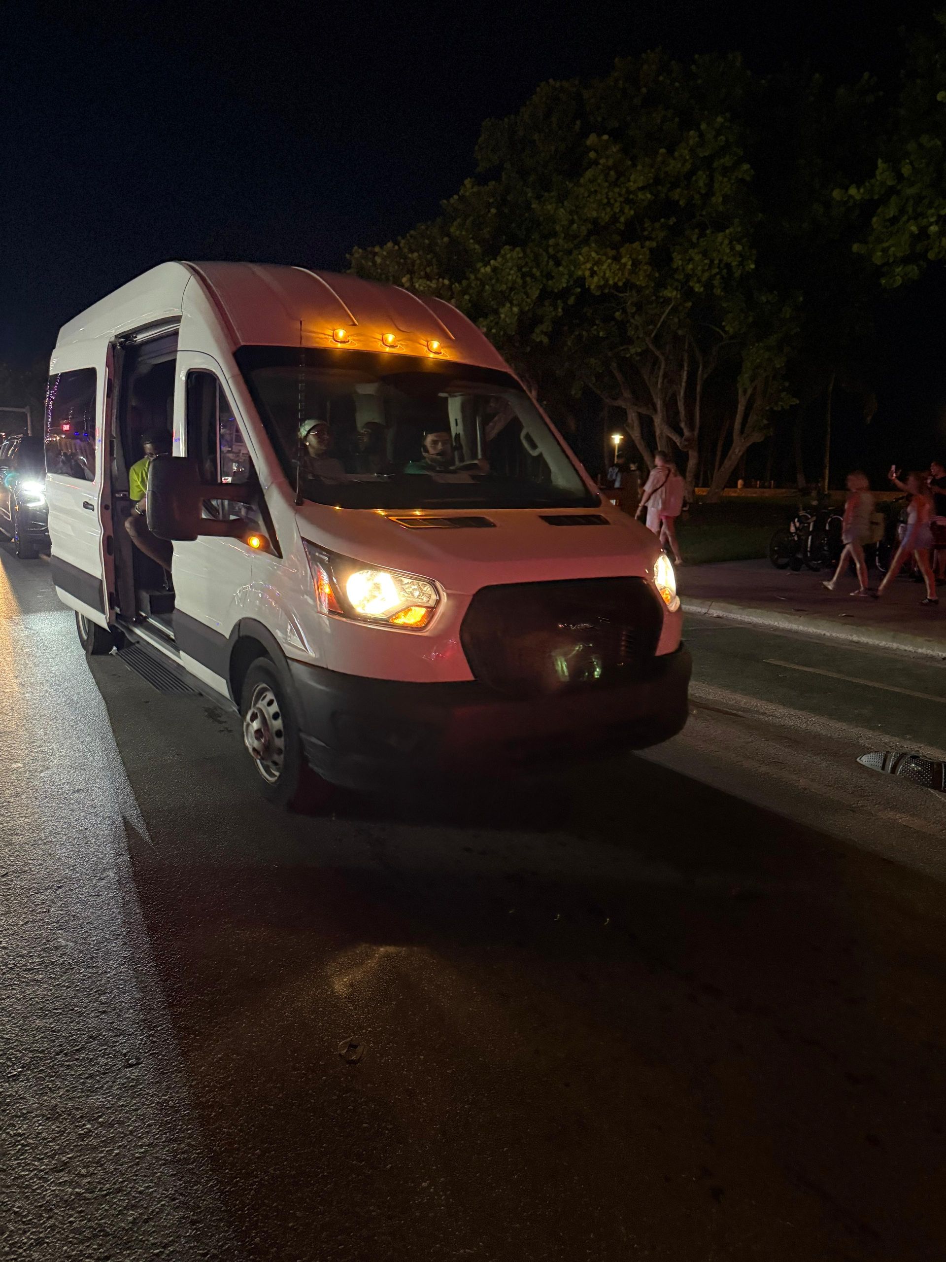 Miami Bus tour at night passing touring Ocean Drive