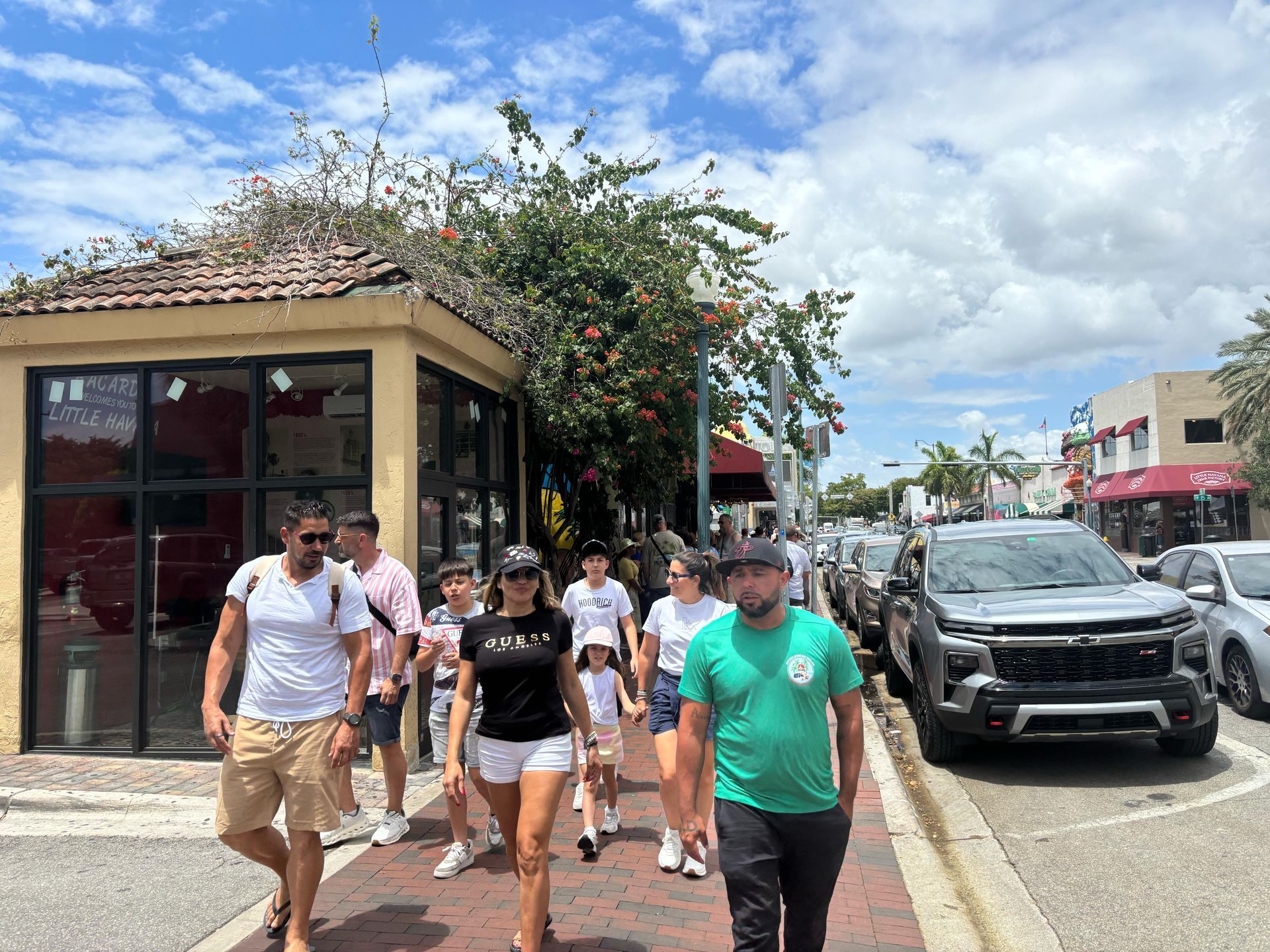 “Tour guide with visitors at Little Havana hop-off point”
