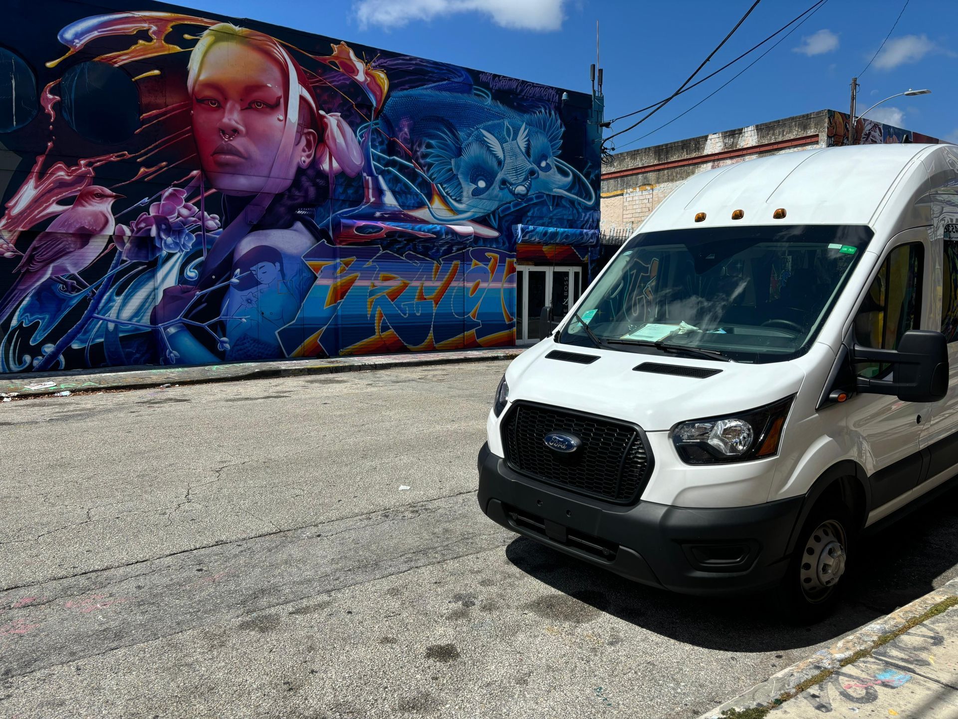 White Miami tour Bus on the 5 in 1 bus tour parked in Wynwood Walls