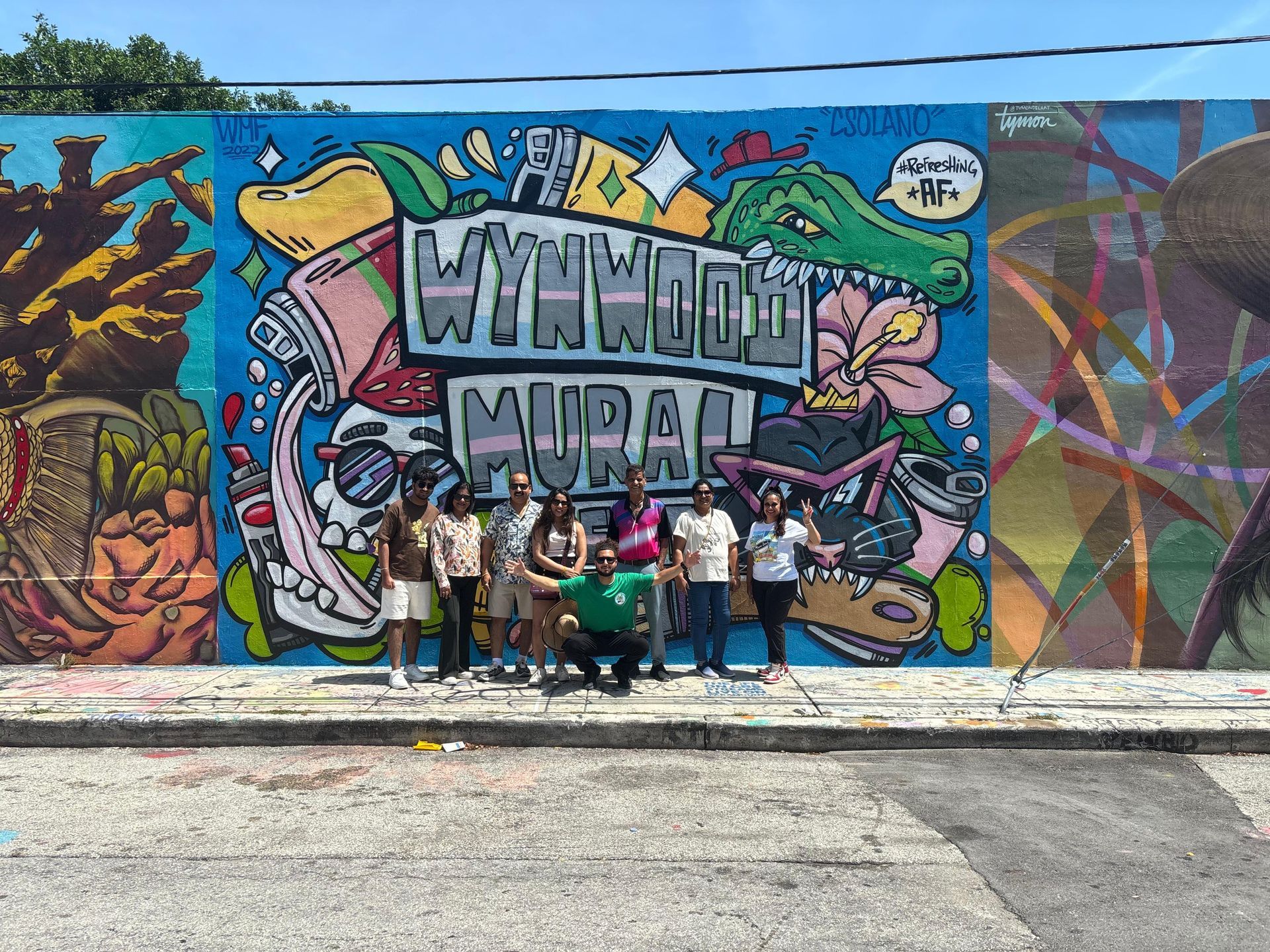 Miami 5 in one city tour in Wynwood Wood Walls passengers taking photos with a colorfull mural behind them