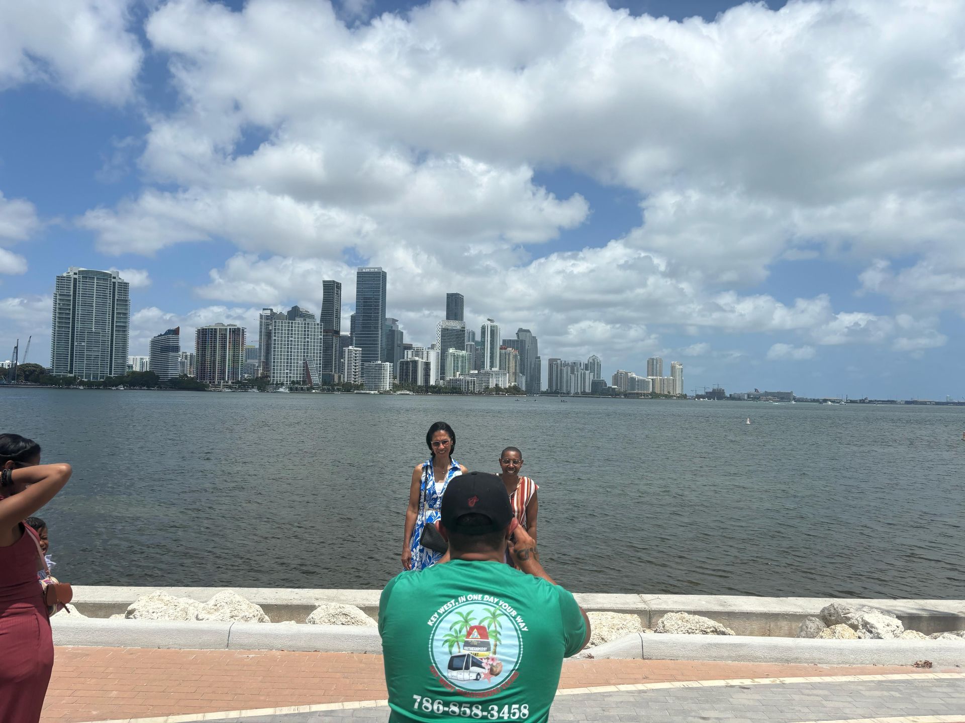 Guests enjoying a skyline photo stop during the Miami Sightseeing Bus tour, with panoramic views of Downtown Miami along the waterfront.

