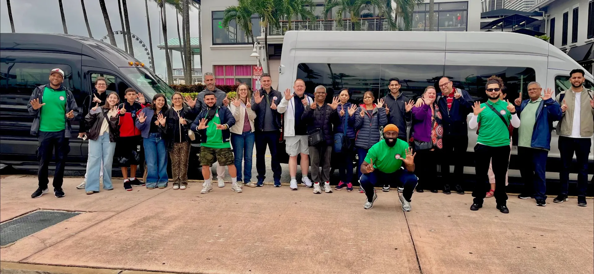 Group of guests in front of two Miami tour buses at Bayside Marketplace enjoying the Miami 5-in-1 city tour experience.