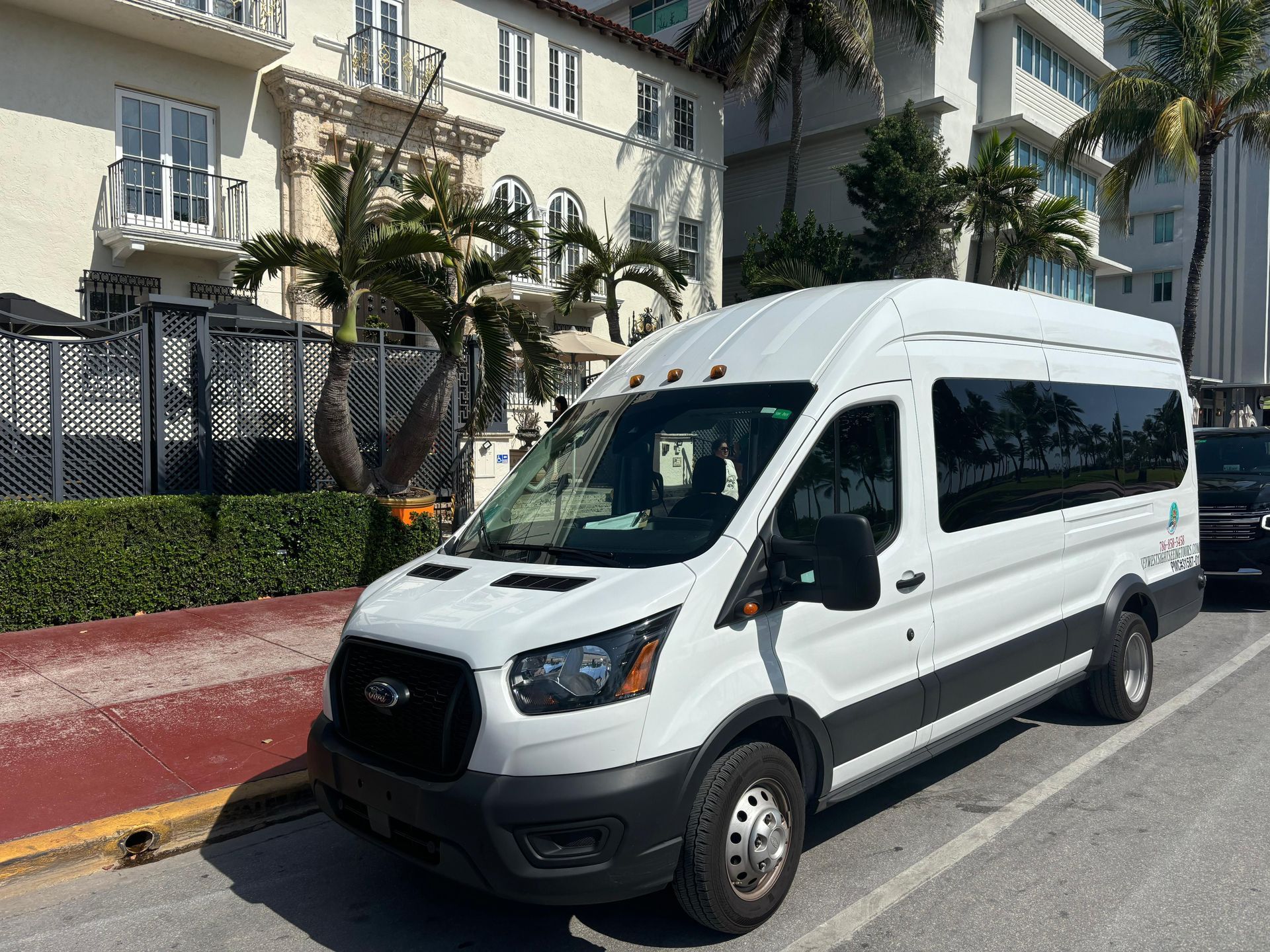 Small Group Bus tour in Miami parked in Ocean Drive in front of the Versace Mansion