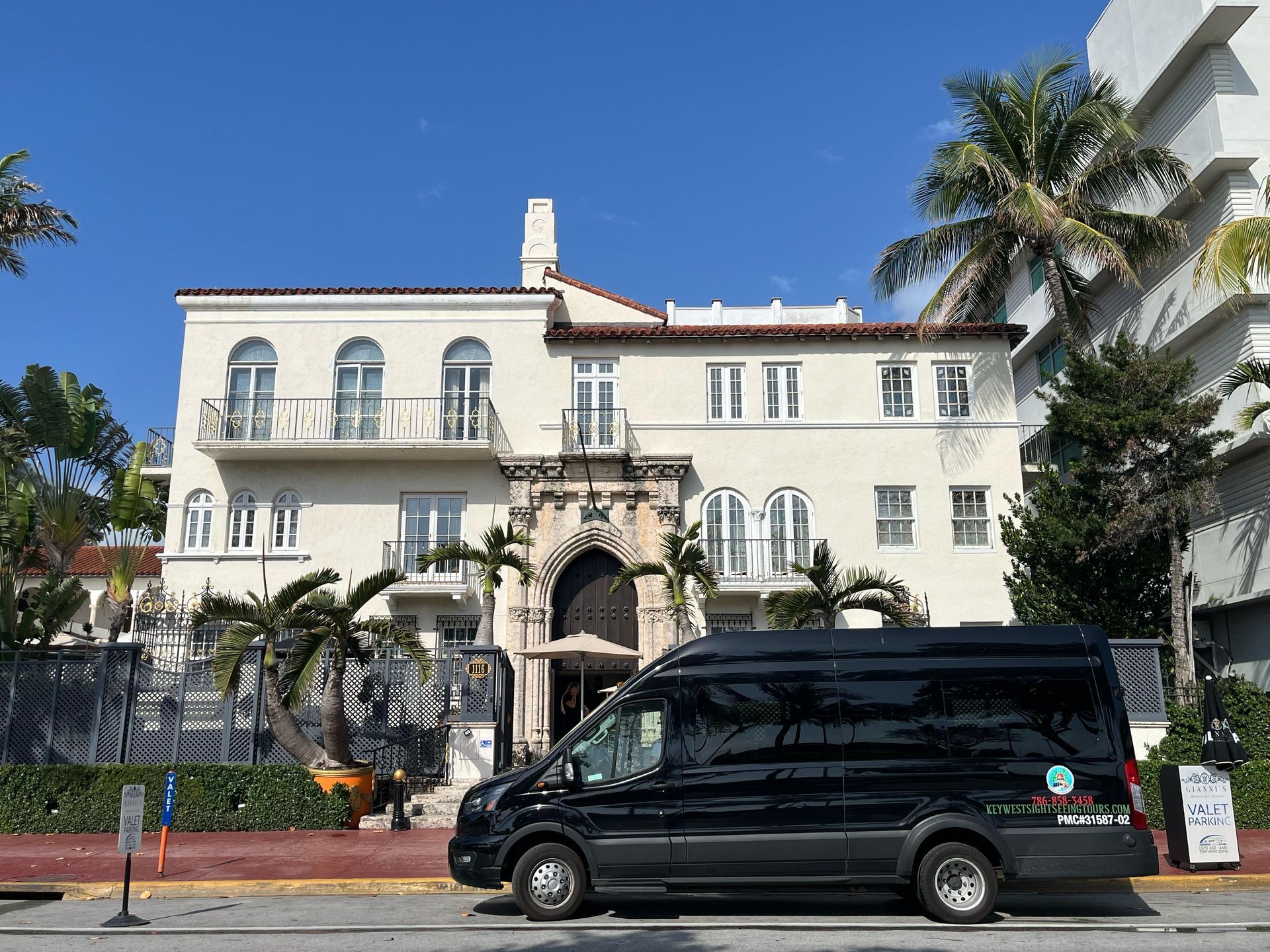 Miami Tour Bus parked in front of the iconic Versace Mansion on Ocean Drive
