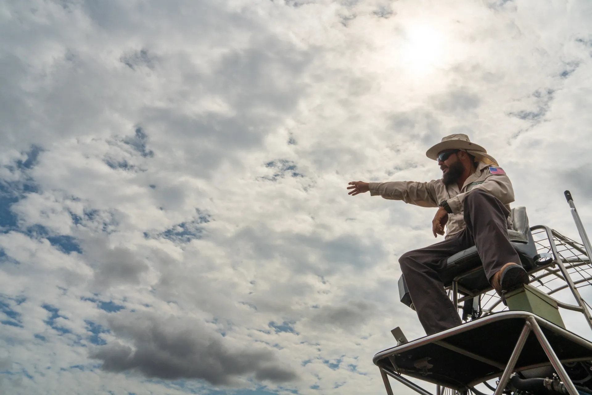 Airboat captain guiding visitors through the Florida Everglades during Everglades boat tours.