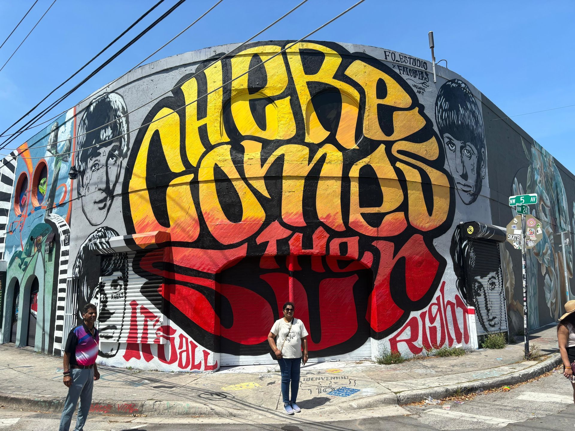 Miami Semi Private City Tour in Wynwood Walls, passengers taking selfies with a colorful mural in the background