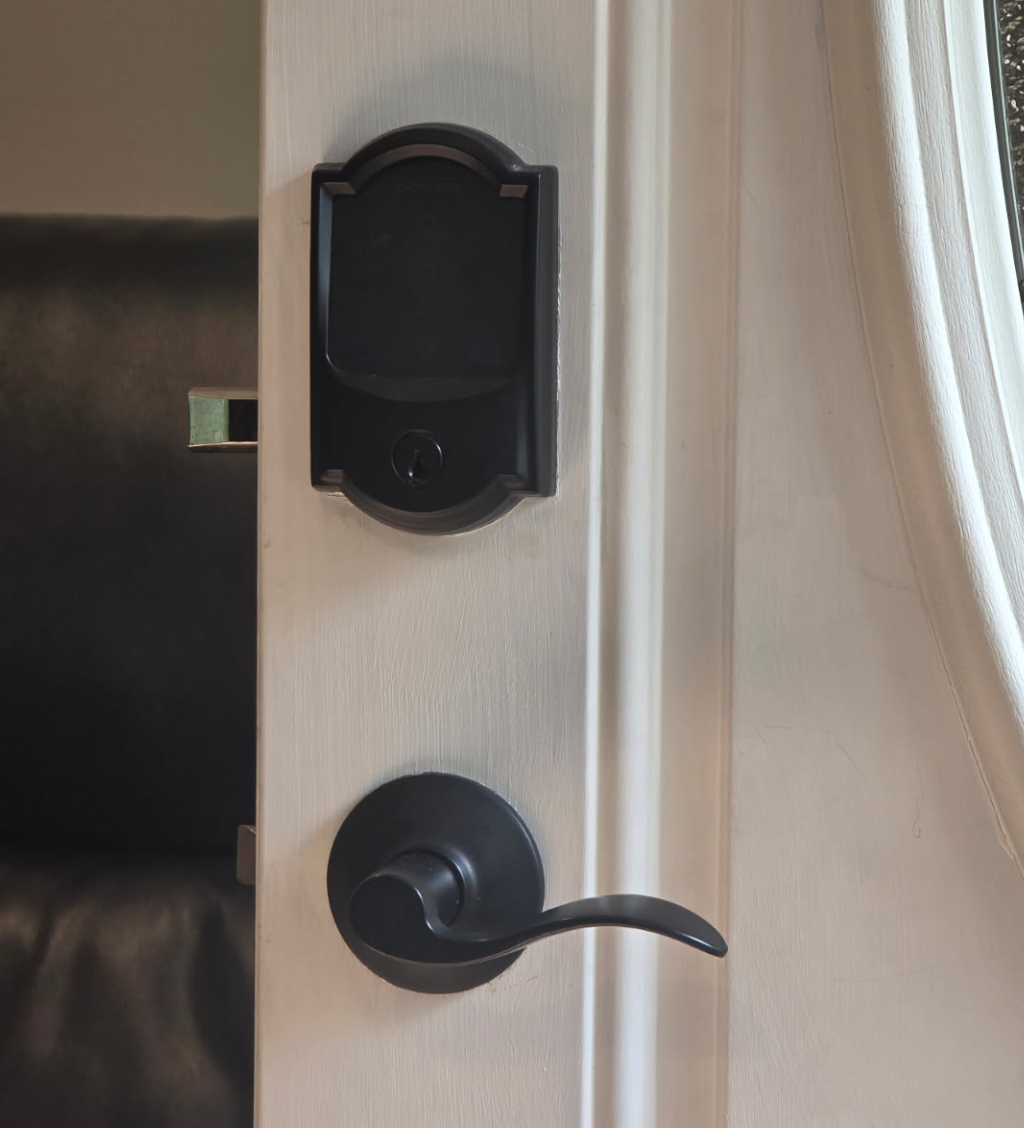 A close up of a digital door lock on a wooden door.