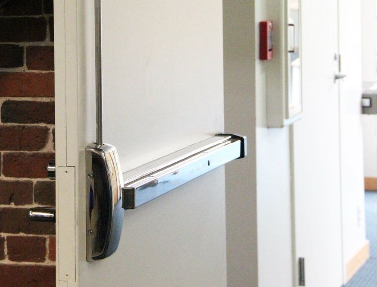 A door with a panic bar attached to it