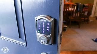 A close up of a digital door lock on a wooden door.