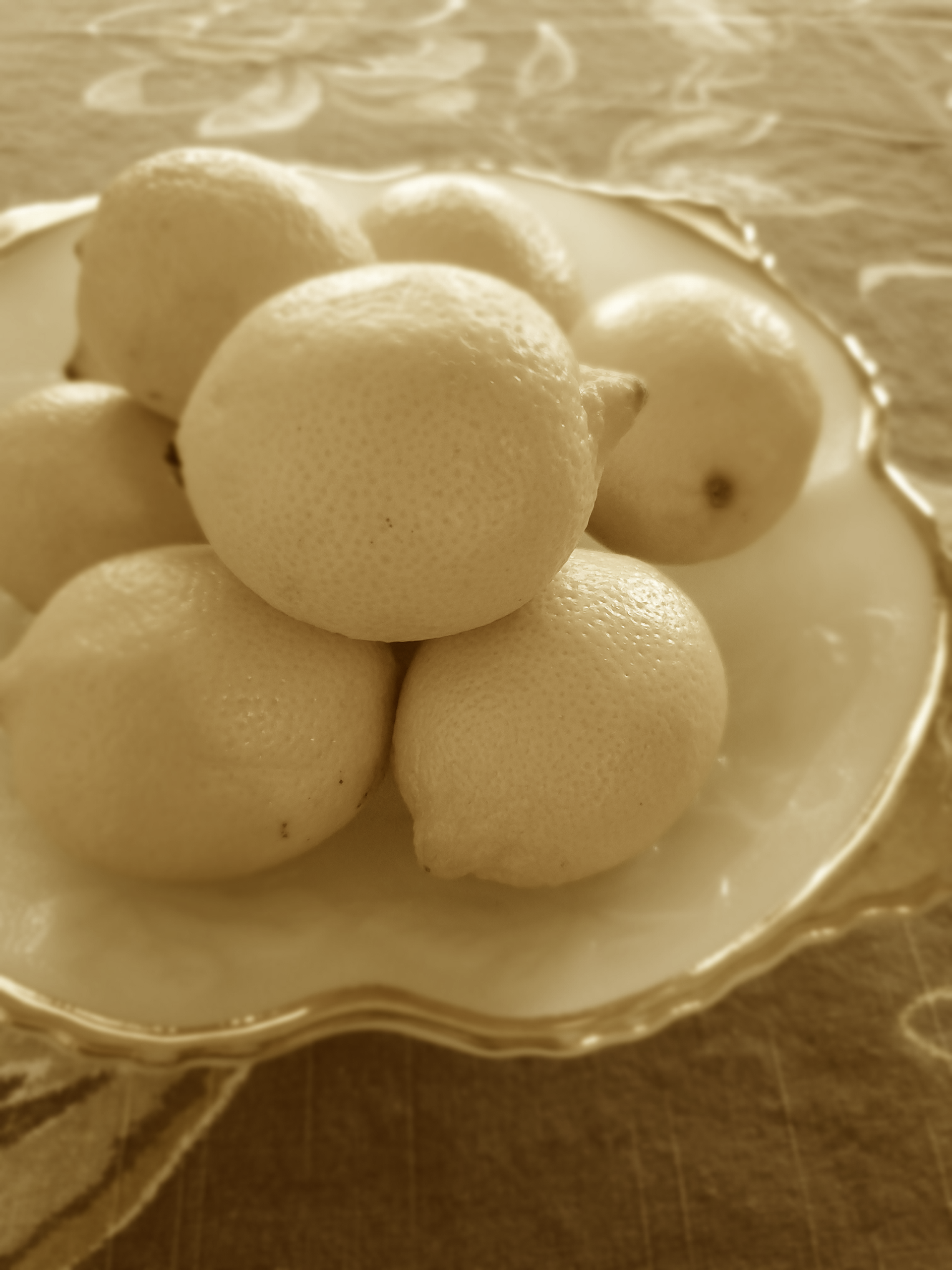 A plate of lemons sits on a table