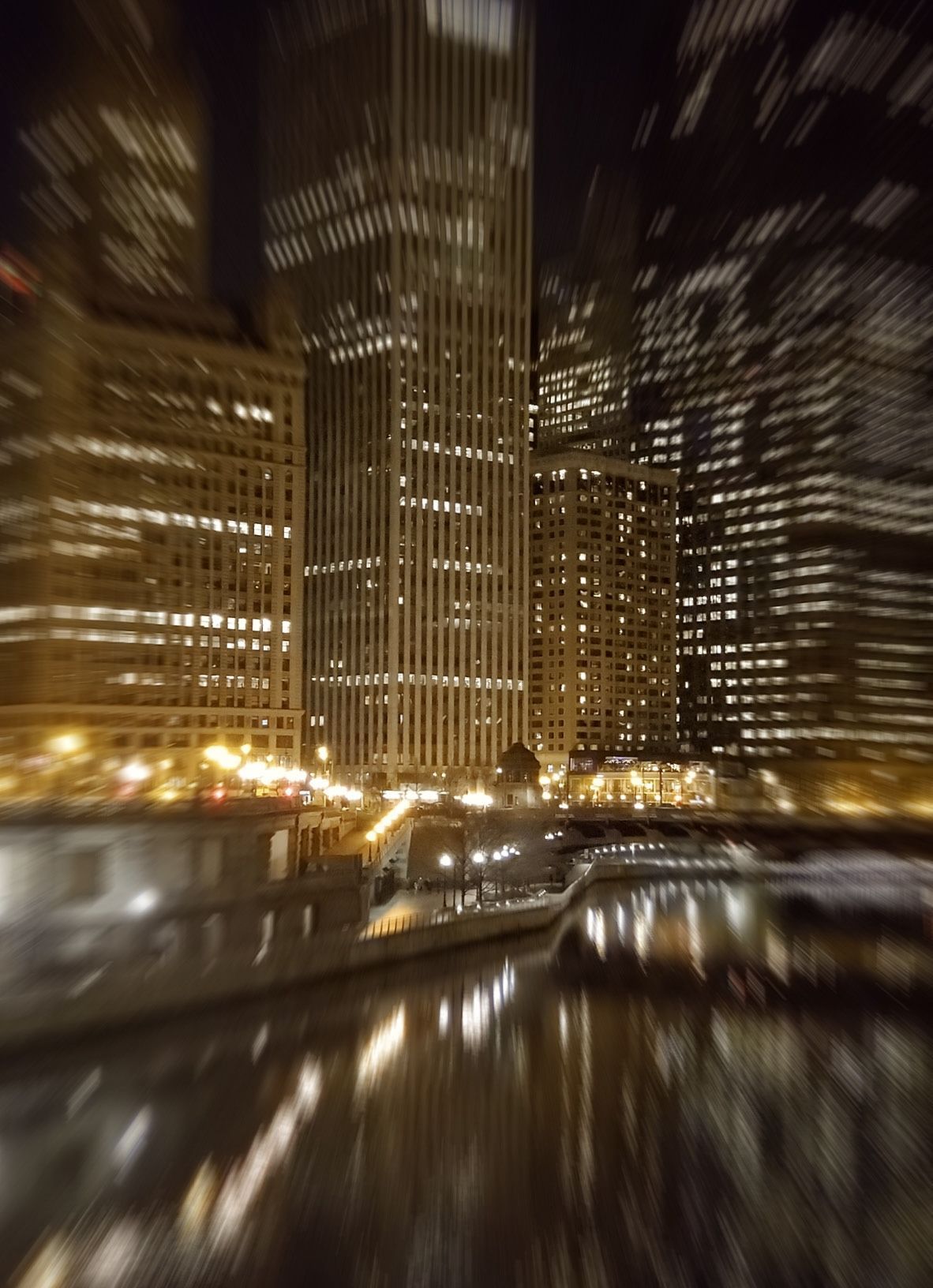 a blurry photo of a city with a rivier in the foreground