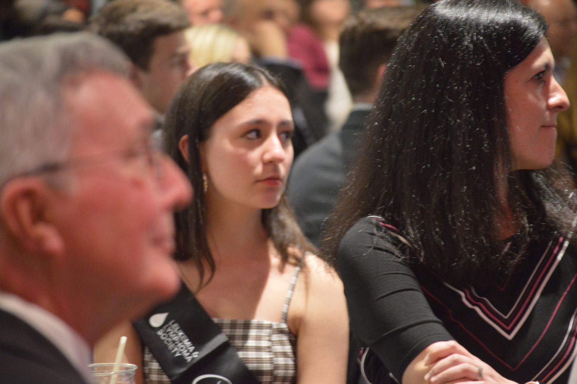 A group of people are sitting at a table in a room.