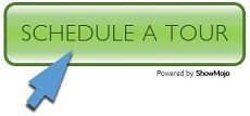 A green button with a blue arrow pointing to it that says schedule a tour.