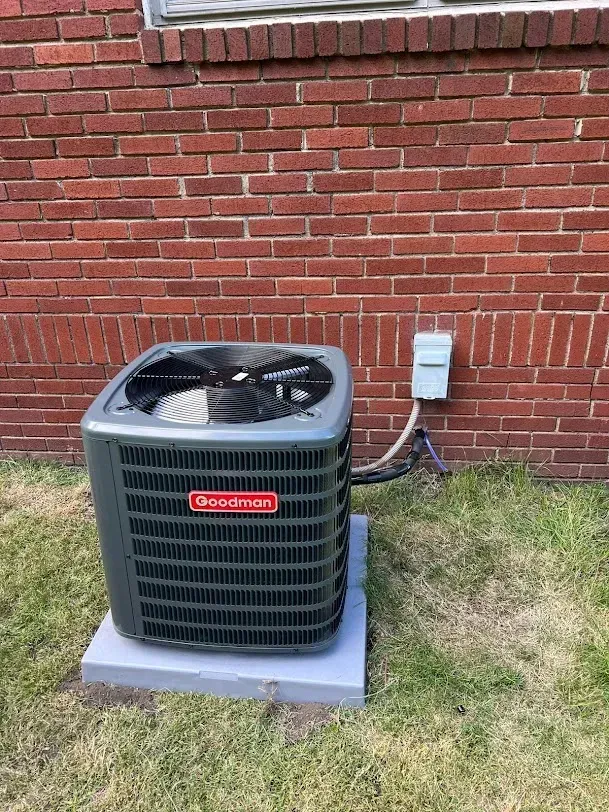 Living room with wood trim, rug, sofa, desk, and view into a stairwell.