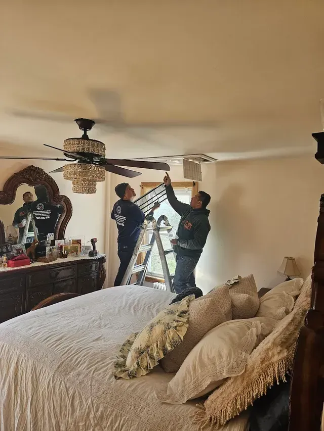 Living room with wood trim, rug, sofa, desk, and view into a stairwell.